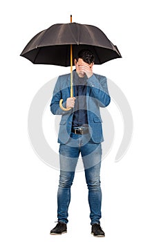 Full length portrait of sad and pessimistic businessman standing under open umbrella facepalm gesture symbolizing a fail isolated