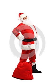 Full length portrait of a Santa Claus posing near a bag