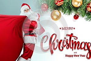 Full length portrait of a Santa Claus posing near a bag full of gifts isolated on white background