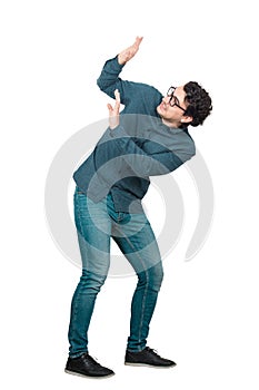 Full length portrait scared man keeps hands raised up to protect him from any danger, isolated over white background.  Nerd