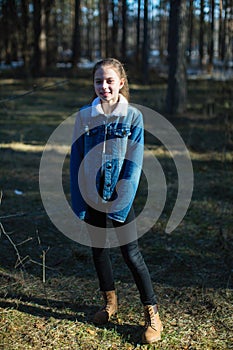 Full-length portrait of a schoolgirl in a denim jacket