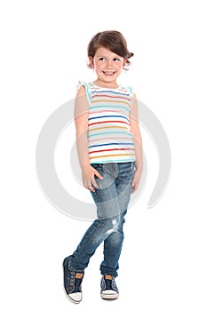 Full length portrait of shy little girl in casual outfit