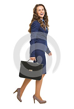 Full length portrait of smiling business woman with briefcase go