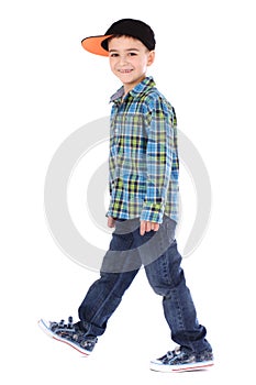 Full length portrait of smiling little boy in jeans and cup