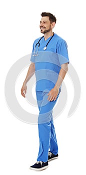 Full length portrait of smiling male doctor in scrubs isolated. Medical staff