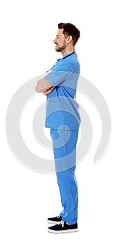 Full length portrait of smiling male doctor in scrubs. Medical staff