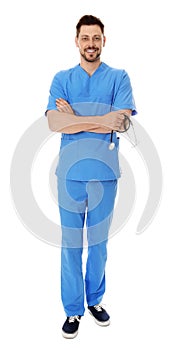 Full length portrait of smiling male doctor in scrubs on white. Medical staff