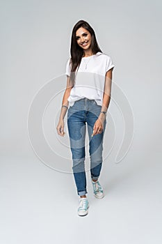 Full length portrait of a smiling pretty woman  over white background.