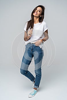 Full length portrait of a smiling pretty woman  over white background.