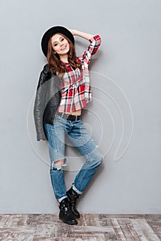 Full length portrait of a smiling pretty woman posing