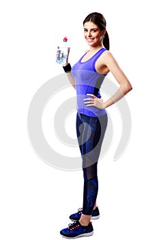 Full-length portrait of a smiling sport woman holding bottle with water