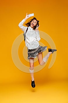 Full length portrait of a smiling teenage schoolgirl