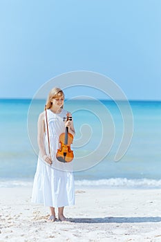 Full length portrait of smiling woman in dress on seacoast