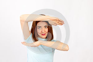 Full-length portrait of a smiling woman showing her palms isolated on a white background. I look at the camera