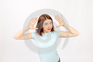 Full-length portrait of a smiling woman showing her palms isolated on a white background. I look at the camera