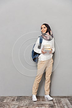 Full length portrait of a smiling young arabian woman