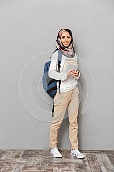 Full length portrait of a smiling young arabian woman