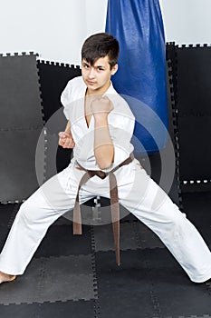 Full length portrait of teenage boy in kimono training ashihara