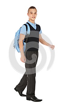 Full length portrait of teenage boy in school uniform with backpack on white