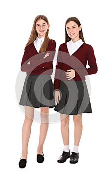 Full length portrait of teenage girls in school uniform on white photo