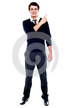 Full length portrait of teenager pointing away