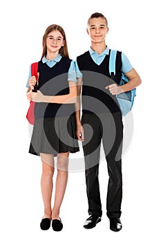 Full length portrait of teenagers in school uniform with backpacks