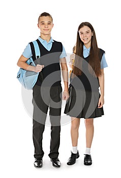 Full length portrait of teenagers in school uniform with backpacks on white