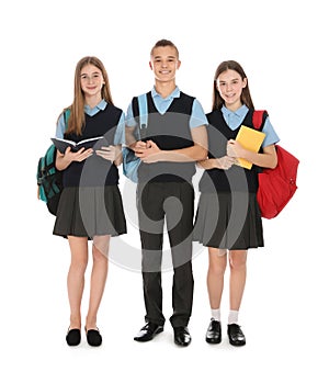 Full length portrait of teenagers in school uniform on white