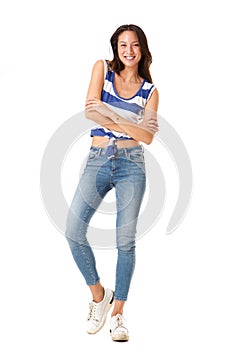 Full length trendy young asian woman smiling with arms crossed against isolated white background