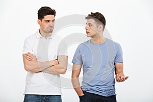 Full length portrait of two upset young men arguing