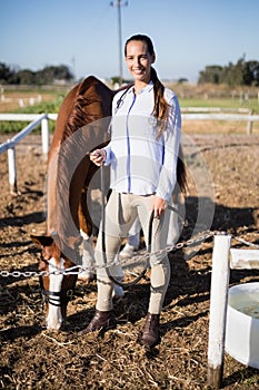 Full length portrait of vet standing by horse