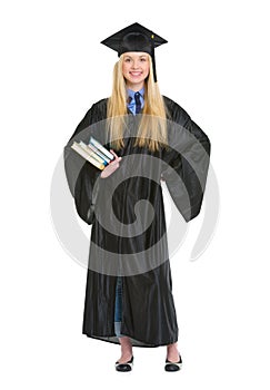 Full length portrait of woman in graduation gown