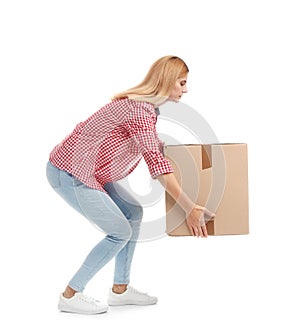 Full length portrait of woman lifting carton box