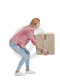 Full length portrait of woman lifting carton box on white background