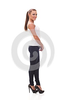 Full length portrait woman in a white tank top and jeans