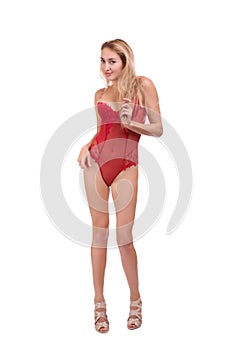 Full length portrait of young beautiful blonde woman in red underwear posing isolated over white background