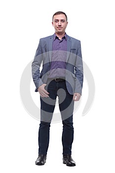 Full length portrait of a young businessman standing with his hands in the pockets.