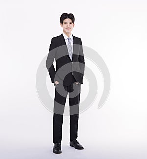 Full length portrait of young businessman standing with his hands in the pockets