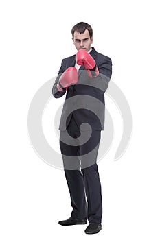 Full length portrait of a young businessman in suit with red boxing gloves