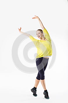 Full-length portrait of a young cheerful woman standing