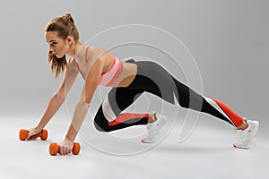 Full length portrait of a young fit sportsgirl doing push-ups