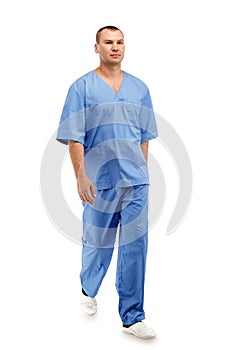 Full length portrait of a young male doctor in a medical surgical blue uniform in motion