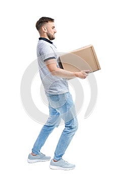 Full length portrait of young man carrying carton box