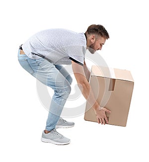Full length portrait of young man lifting carton box
