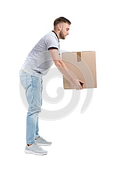 Full length portrait of young man lifting carton box