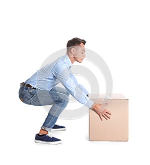 Full length portrait of young man lifting heavy cardboard