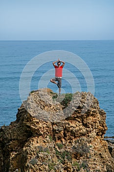 Full length portrait of a young man looking at sea waves . Crete, Greece