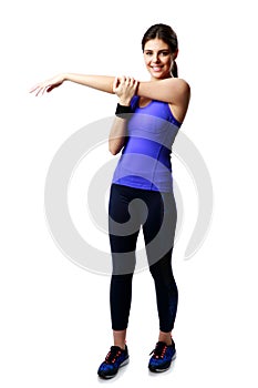 Full-length portrait of a young sport woman stretching hands