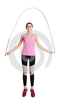 Full length portrait of young sportive woman training with jump rope