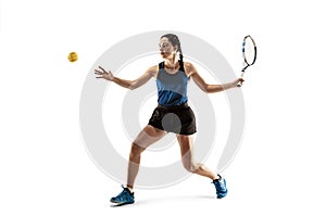 Full length portrait of young woman playing tennis isolated on white background